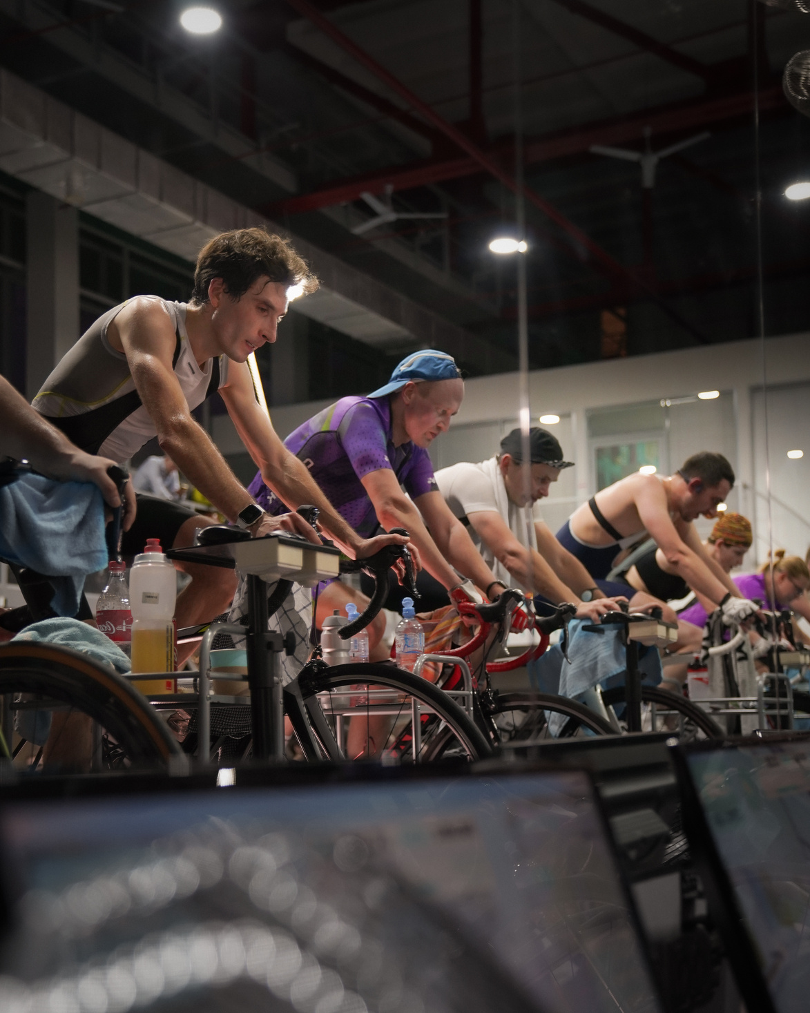 People on Bikes Cycling Together in Gym